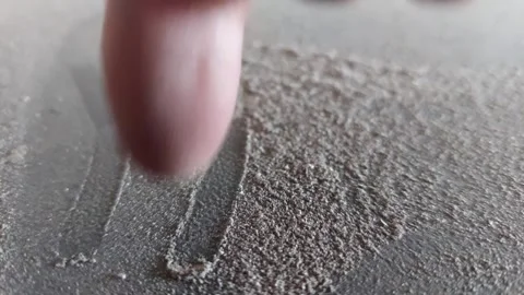 Writing "YES" with a finger in a thick layer of dust Stock Footage 333643629