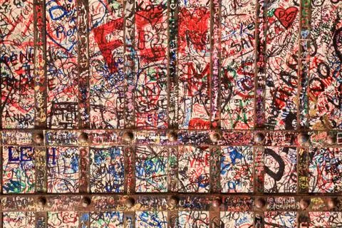 Writings on a wall an an iron gate Stock Photos