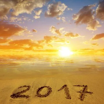 Written 2017 on the sandy beach at sunset. Stock Photos