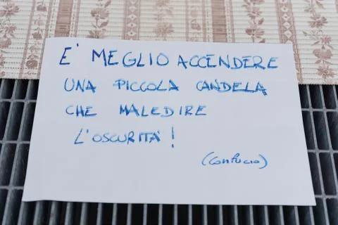Written on the paper: "it is better to light a small candle than to curse the Fotos Stock