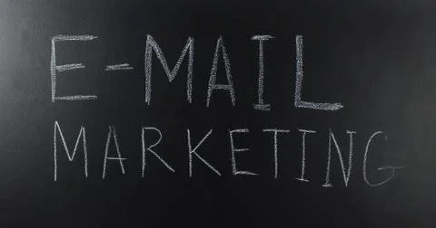 Written with a text: E-mail marketing on blackboard. Stock Photos