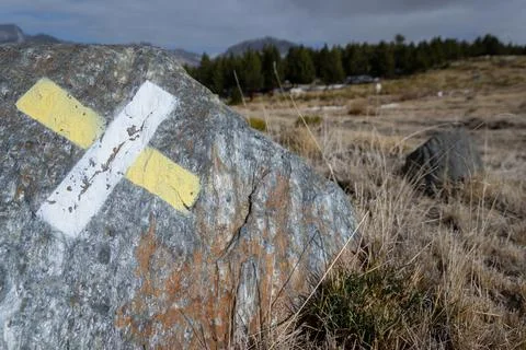 Wrong direction short trail sign painted on a rock Stock Photos