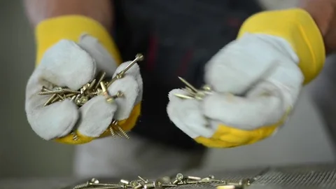 Wrong Screws on the Construction Site. Angry Worker Looking Hardly For the Right Stock Footage 77434415