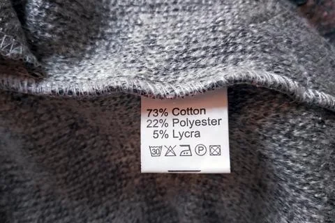 Wrong side of a gray dress made of wool, the composition is specified: cotton Stock Photos
