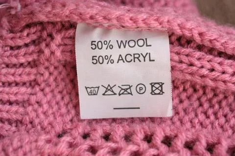 Wrong side of a pink knitted sweater made of wool, the composition is specifi Stock Photos