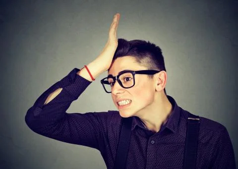 Wrong. Silly man slapping hand on head having duh moment Stock Photos