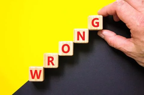 Wrong symbol. Concept word Wrong on beautiful wooden blocks. Beautiful yellow Stock Photos