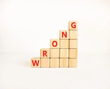 Wrong symbol. Concept word Wrong on beautiful wooden blocks. Beautiful whit.. Stock Photos