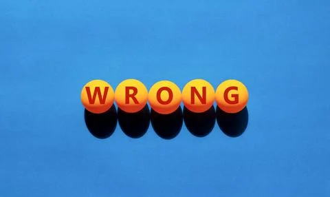 Wrong symbol. Concept word Wrong on beautiful yellow tennis ping pong balls.  Stock Photos