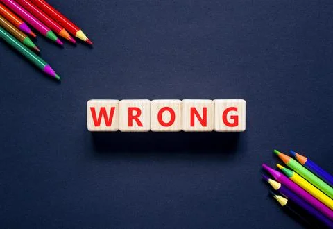 Wrong symbol. Concept word Wrong on beautiful wooden blocks. Beautiful black  Stock Photos