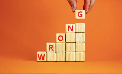 Wrong symbol. Concept word Wrong on beautiful wooden blocks. Beautiful orange Stock Photos
