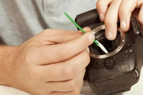 Wrong way cleaning sensor of digital camera by cleaning stick uncarefully Stock Photos