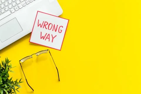 Wrong way icon on office desk - yellow, top view copy space Stock Photos