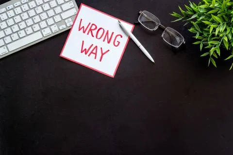 Wrong way icon on office desk - black, top view copy space Stock Photos