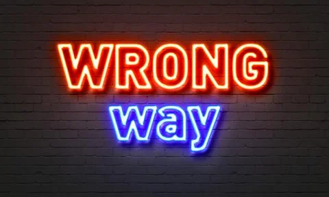 Wrong way neon sign on brick wall background. Stock Illustration