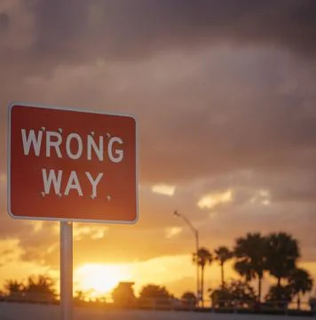 Wrong Way Sign with Dramatic Sunset Stock Photos