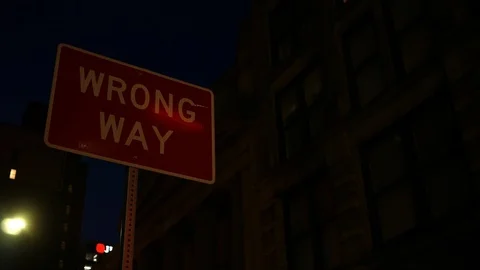 Wrong Way sign during night time in city Stock Footage 103066363