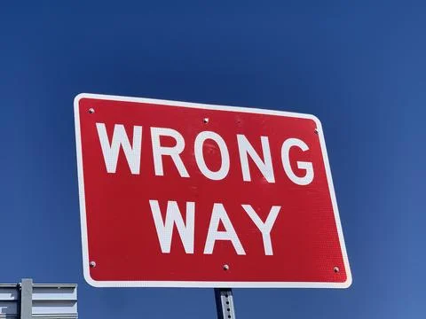 Wrong way sign post Stock Photos