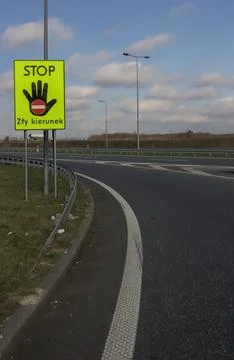 Wrong Way Stop Sign on Polish Highway Exit Fluorescent Yellow Warning Sign. Stock Photos