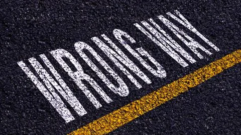 Wrong way, wrong way text written and yellow line on asphalt road ground. Stock Illustration