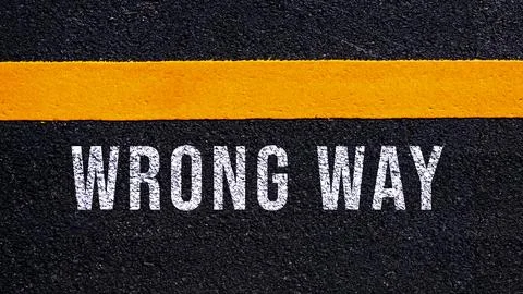 Wrong way, wrong way text written and yellow line on asphalt road ground. Stock Illustration