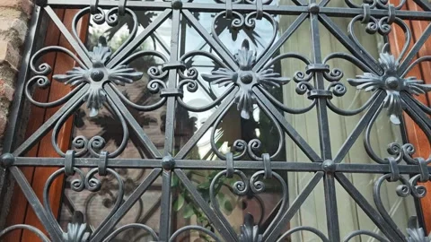 Wrought iron window grill protecting glass window Видео 310300279