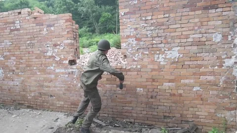 WS of American soldier throwing grenade out window Stock Footage 79973036