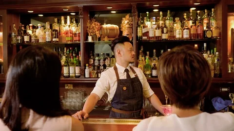 WS Bartender showing alcohol to customers Stock Footage