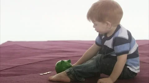 WS Boy (4-5) inserting coins in piggy bank Stock Footage 11339601