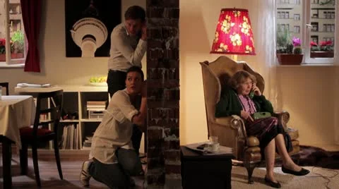 WS of a couple eavesdropping on their neighbor talking on the phone, split Stock Footage 10703143