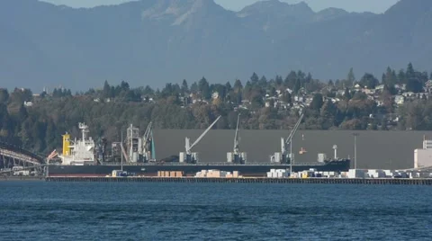 WS freighter at dock with mountains in BG. Port of  Vancouver, BC Canada Stock Footage 53048465