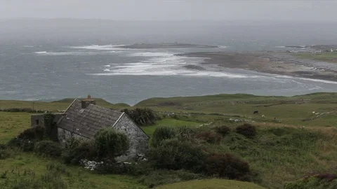 WS HA LD Stone Cottage on Hillside near Ocean / Ireland Stock Footage 69966936