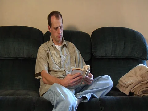 WS man reading book Stock Footage 37013953