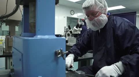 WS Man working in Cleanroom with other worker  in background Stock Footage 10895934