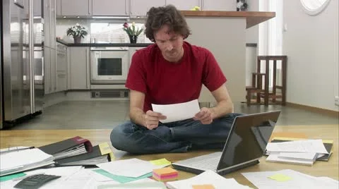 WS PAN Man using laptop and doing paperwork Stock Footage
