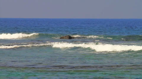 WS pan ocean with rocks and small waves Stock Footage 5828340