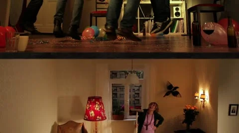 WS of a senior woman hitting the ceiling while her neighbors dance on the floor Stock Footage