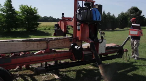 WS side angle of portable sawmill cutting log Stock Footage 40472430