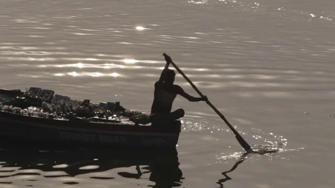 WS Silhouette of man rowing boat in Ganges river / Varanasi, India Stock Footage 69958812