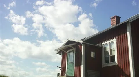 WS T/L View of moving clouds over cottage / Stockholm Stock Footage 11339527