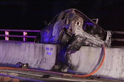 WS Torched Car Smokes on Median Stock Footage