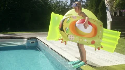 WS TU Portrait of girl with inflatable toys on poolside Stock Footage