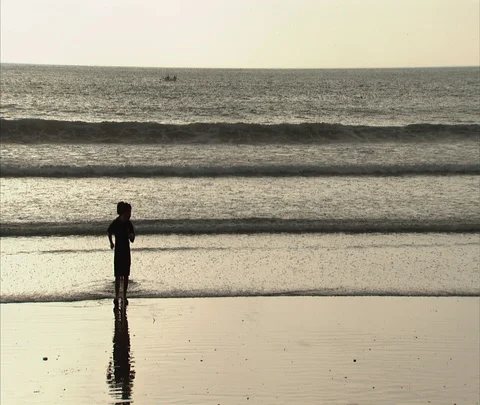 WS two kids playing at water's edge Stock Footage 86747096