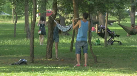 WTying a hammock in Central Park, Cluj-Napoca Stock Footage 55094189
