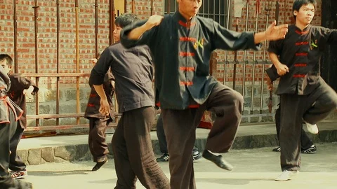 Wushu Master and Disciples Synchronized Kungfu at Martial Arts School Stock Footage 123888081