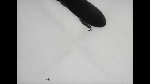WW1 - Zeppelin and biplane fly in air Stock Footage