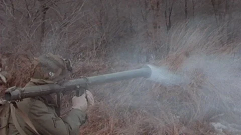 WW2: American troops Recently fired bazooka is still smoking in a battle Stock Footage 111039316