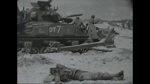 WW2 - D-Day - Allied tank drives along beach in Normandie Stock Footage