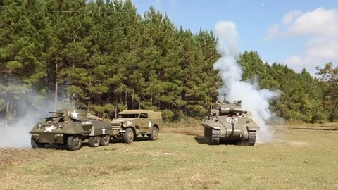 WW2 explosion next to US tank destroyer, advance armor scout car and jeeps Stock Footage 78984472