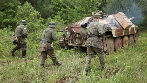 WW2 German Hetzer tank destroyer and Swimwagon advance with soldiers Stock Footage 78985780